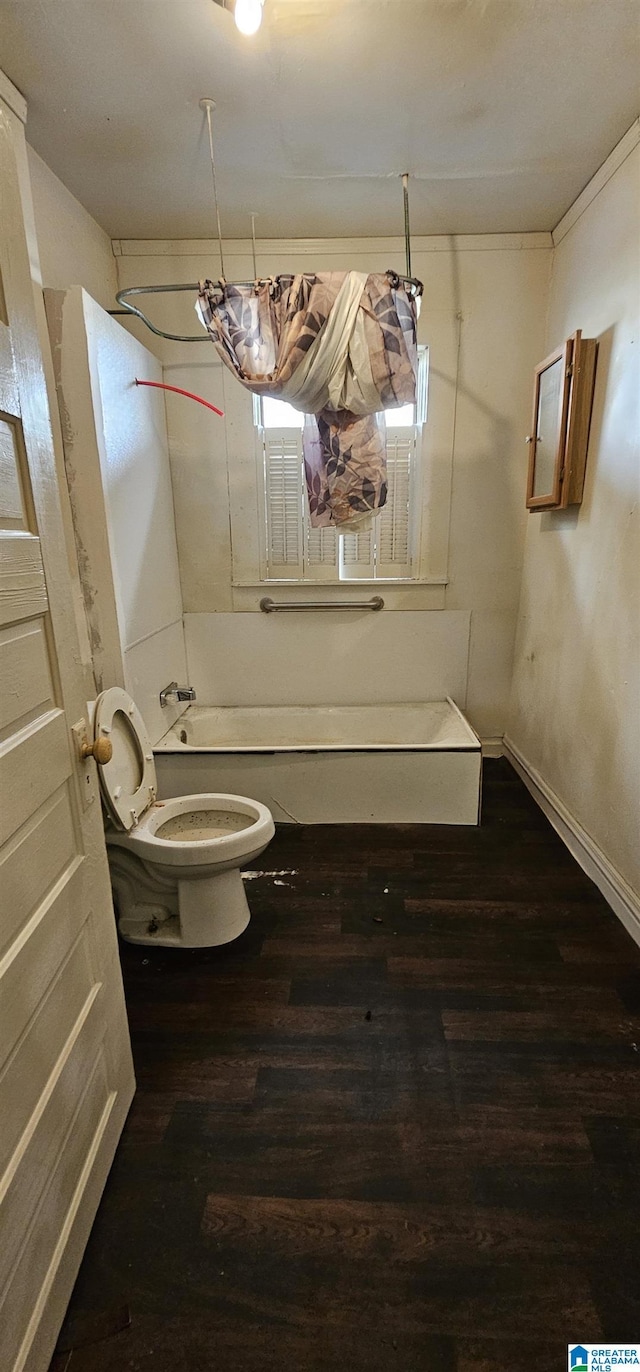 18 6th Ave S, Birmingham, AL 35205 - bathroom featuring bathtub / shower combination, baseboards, wood finished floors, and toilet