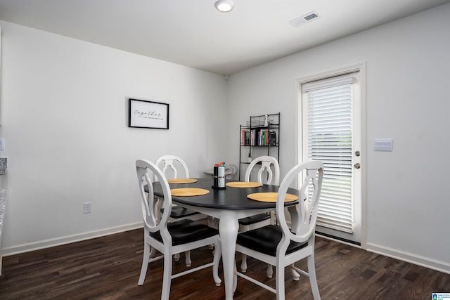 dining area featuring dark wood finished floors, baseboards, visible vents, and recessed lighting