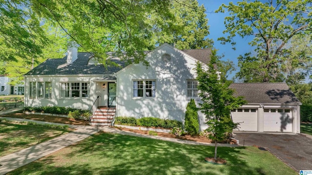201 La Prado Pl, Homewood, AL 35209 - view of front facade featuring a chimney, a front lawn, aphalt driveway, a garage, and roof with shingles