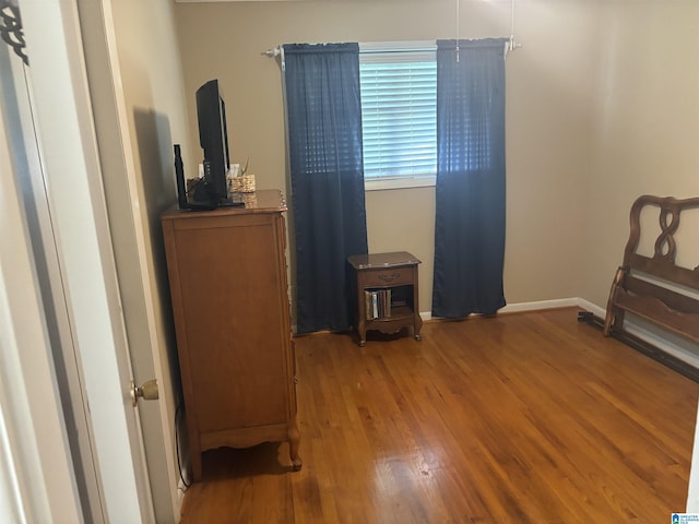bedroom with wood finished floors and baseboards