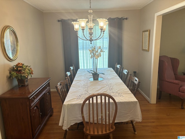 dining area featuring baseboards, ornamental molding, an inviting chandelier, and dark wood-style flooring