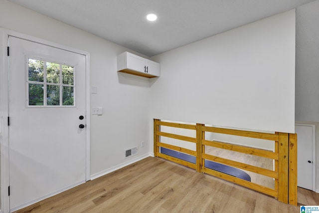 laundry room featuring baseboards, light wood-style floors, visible vents, and recessed lighting