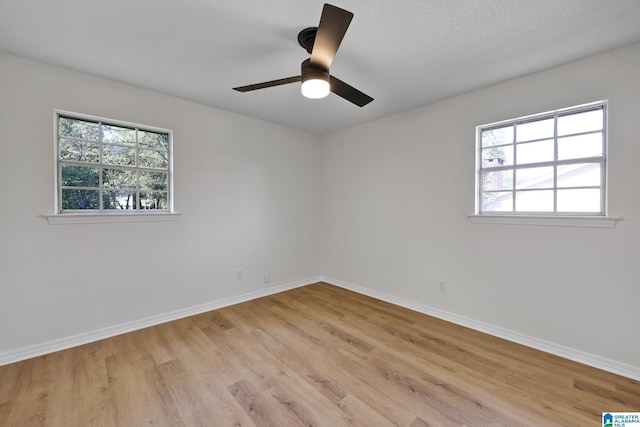 empty room with baseboards and light wood-style floors