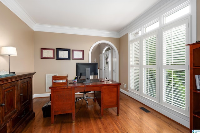 office space featuring wood finished floors, visible vents, ornamental molding, and baseboards