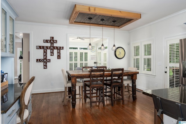 dining area featuring dark wood-style flooring, ceiling fan, crown molding, and baseboards