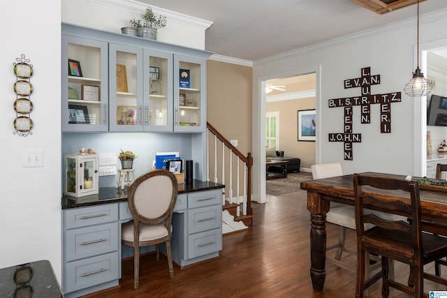 office space with a ceiling fan, crown molding, and dark wood finished floors