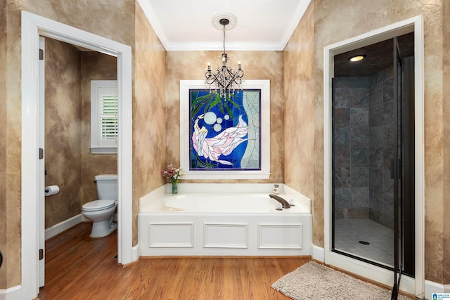 full bath with wood finished floors, an inviting chandelier, toilet, a stall shower, and a garden tub