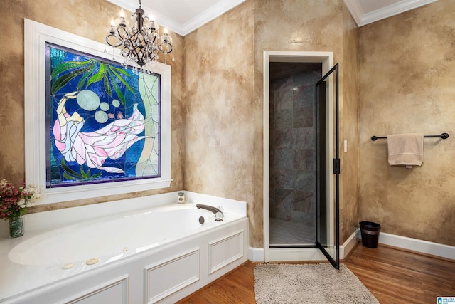 bathroom with an inviting chandelier, a shower stall, a bath, ornamental molding, and wood finished floors
