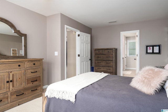 bedroom with baseboards and visible vents