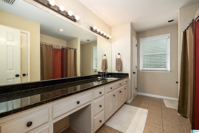 full bathroom with visible vents, vanity, tile patterned flooring, and baseboards