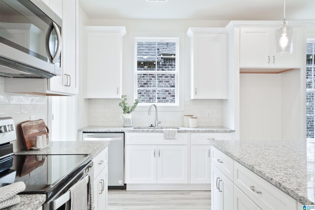 342 Shiloh Creek Dr, Calera, AL 35040 - kitchen with stainless steel appliances, a sink, white cabinetry, and backsplash