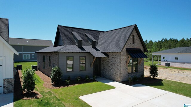 342 Shiloh Creek Dr, Calera, AL 35040 - view of front facade with brick siding, a patio area, a front yard, and a shingled roof
