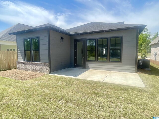342 Shiloh Creek Dr, Calera, AL 35040 - back of house with central AC unit, a shingled roof, brick siding, and a patio area