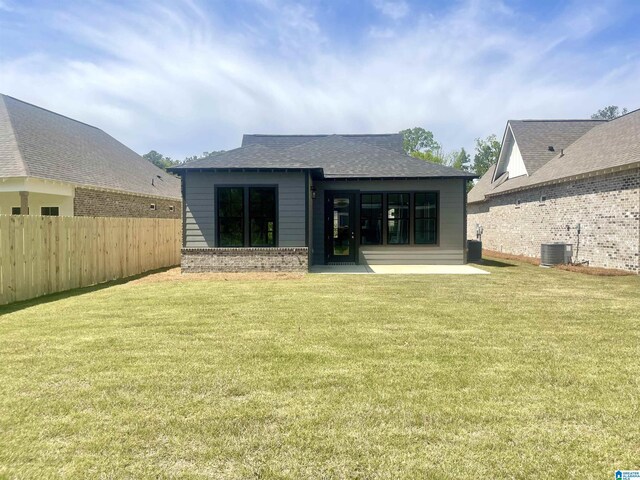 342 Shiloh Creek Dr, Calera, AL 35040 - back of house featuring central AC unit, brick siding, and roof with shingles