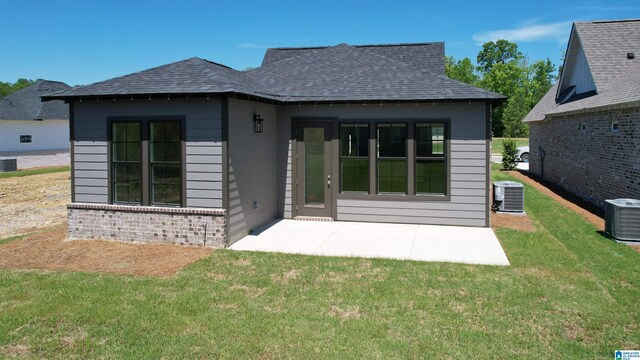 342 Shiloh Creek Dr, Calera, AL 35040 - back of house with central AC unit, a lawn, and a shingled roof