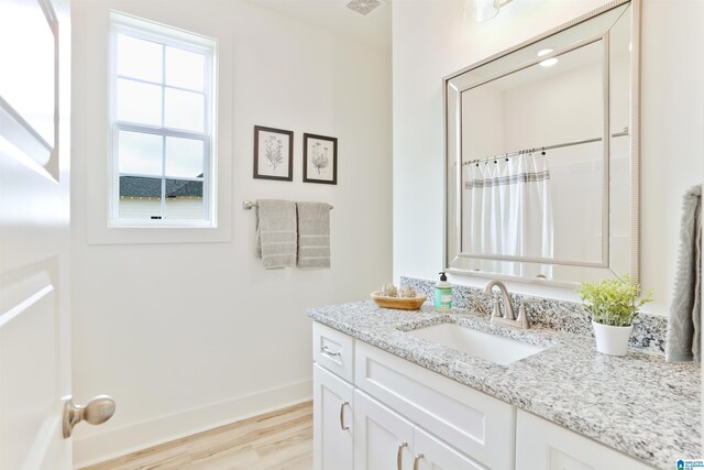 342 Shiloh Creek Dr, Calera, AL 35040 - full bathroom featuring wood finished floors, vanity, baseboards, and a shower with curtain