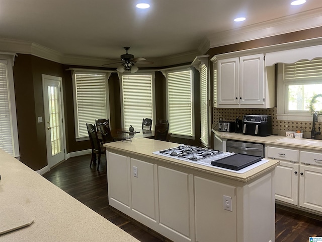 kitchen with light countertops, dishwasher, and white cabinetry