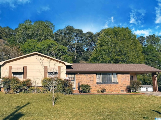 view of front of property with brick siding, an attached carport, concrete driveway, and a front yard