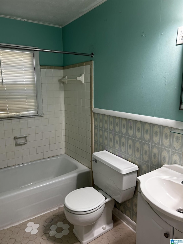 full bathroom with crown molding, tile patterned floors, vanity, bathtub / shower combination, and toilet