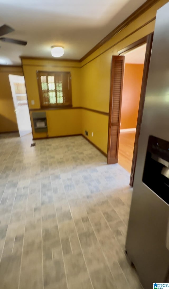 unfurnished dining area featuring crown molding and ceiling fan