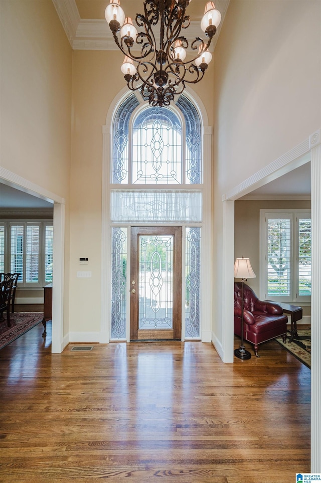 4527 High Court Cir, Hoover, AL 35242 - foyer with crown molding, wood finished floors, baseboards, a high ceiling, and a notable chandelier