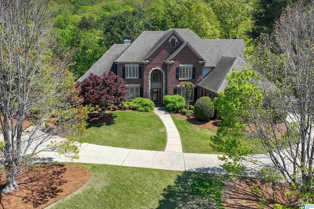 4527 High Court Cir, Hoover, AL 35242 - traditional-style house with brick siding, a view of trees, a shingled roof, and a front yard