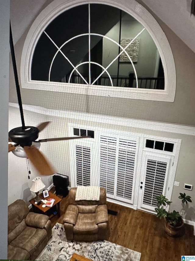 living room with wood finished floors and ceiling fan