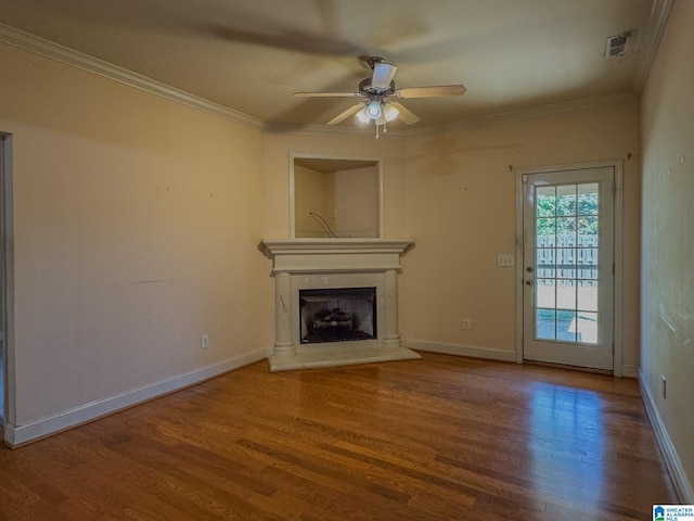 unfurnished living room with crown molding, wood finished floors, and a ceiling fan