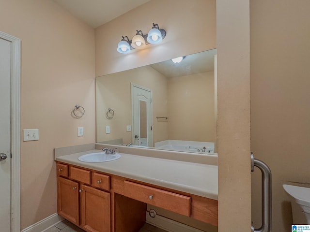 bathroom featuring baseboards, vanity, and a tub