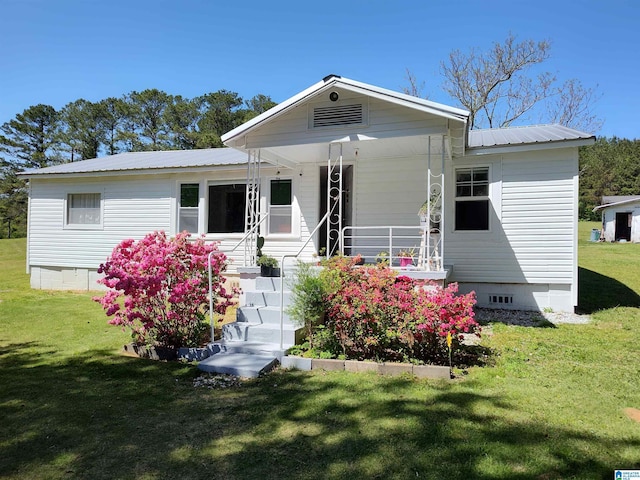 bungalow featuring crawl space, a front lawn, covered porch, and metal roof