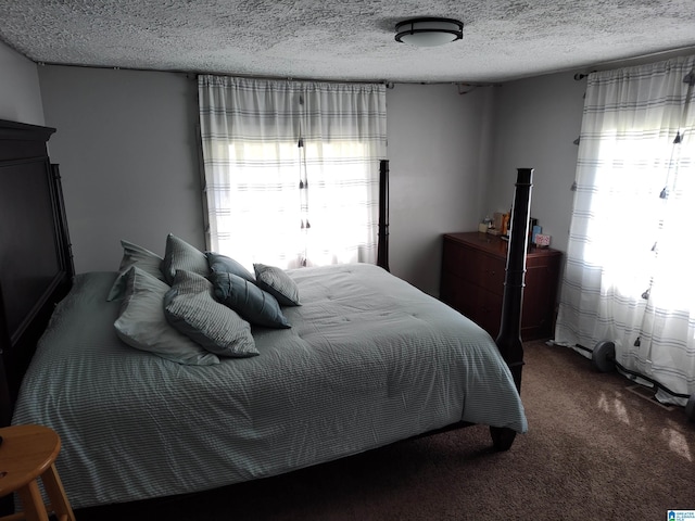 carpeted bedroom with a textured ceiling