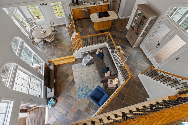 387 Misty Ln, Wedowee, AL 36278 - interior space featuring baseboards, stone tile flooring, stairs, and a towering ceiling