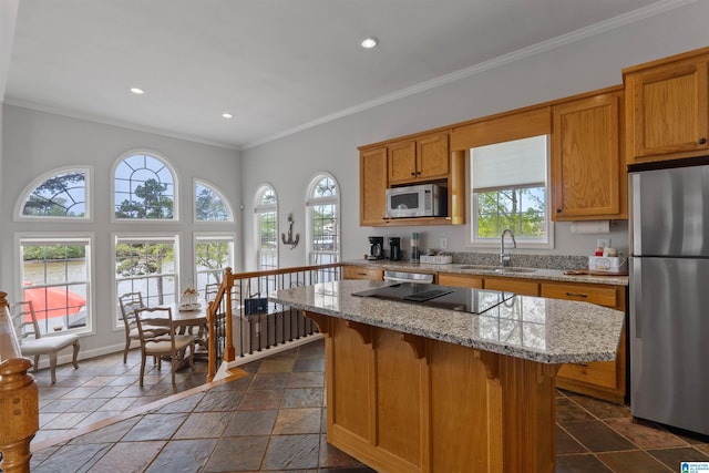 387 Misty Ln, Wedowee, AL 36278 - kitchen featuring a center island, a sink, stone tile floors, crown molding, and appliances with stainless steel finishes