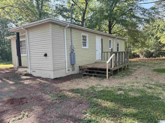 back of property featuring crawl space and a deck