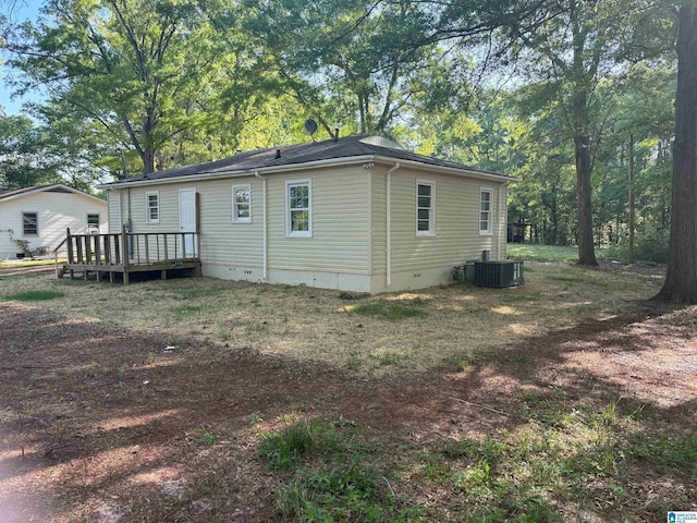 rear view of property with cooling unit, crawl space, and a deck