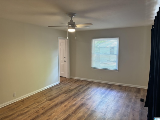spare room with ceiling fan, baseboards, and wood finished floors