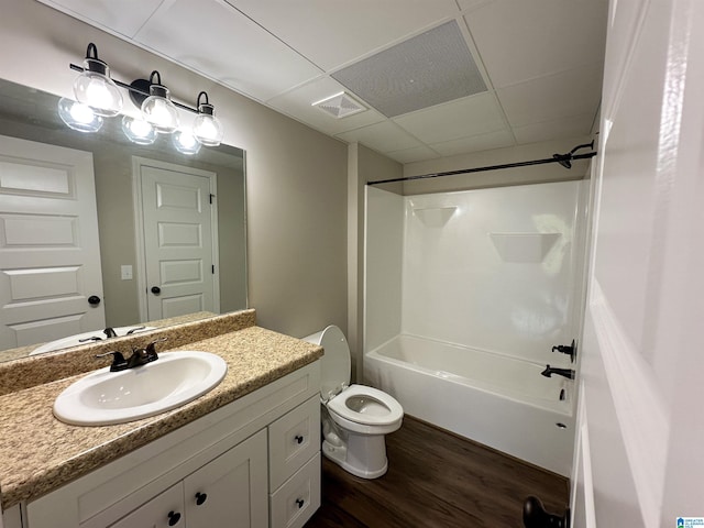 bathroom with washtub / shower combination, wood finished floors, visible vents, toilet, and vanity