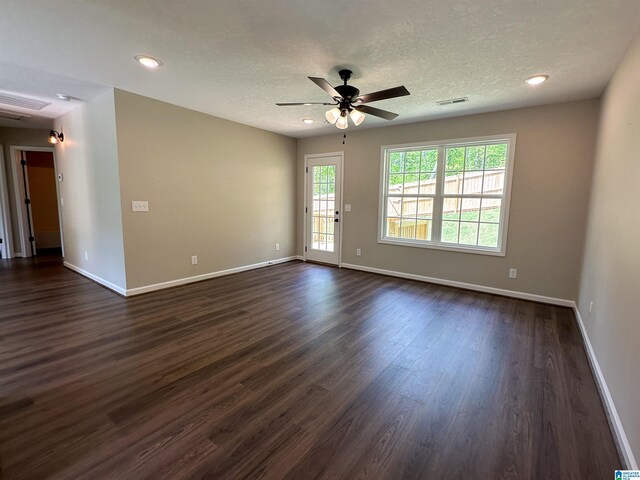 unfurnished room with recessed lighting, a ceiling fan, dark wood-type flooring, baseboards, and a textured ceiling