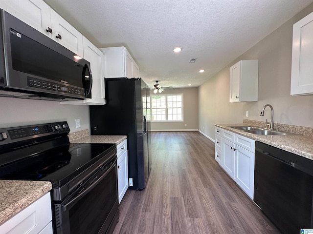 kitchen with a sink, dark wood finished floors, electric range, a ceiling fan, and dishwasher