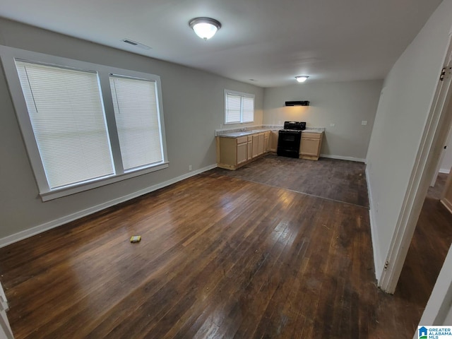 interior space with visible vents, baseboards, dark wood-style floors, and a sink