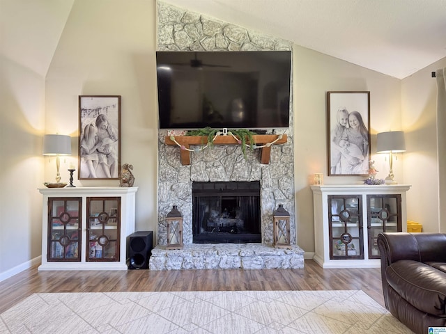 632 Bernard Couch Dr, Anniston, AL 36207 - living room featuring baseboards, wood finished floors, lofted ceiling, and a fireplace
