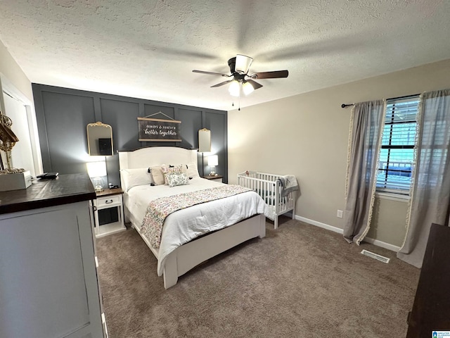 632 Bernard Couch Dr, Anniston, AL 36207 - carpeted bedroom with a textured ceiling, visible vents, ceiling fan, and baseboards