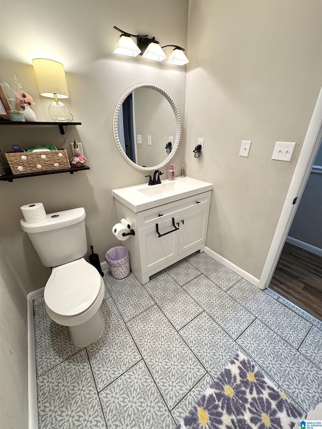 632 Bernard Couch Dr, Anniston, AL 36207 - half bathroom featuring baseboards, tile patterned floors, toilet, and vanity