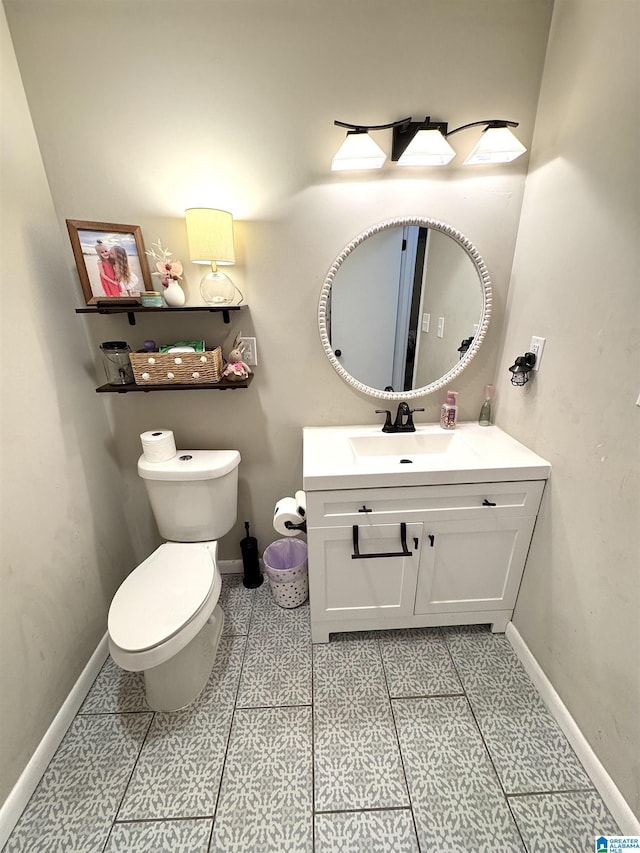 632 Bernard Couch Dr, Anniston, AL 36207 - half bathroom featuring toilet, vanity, and baseboards