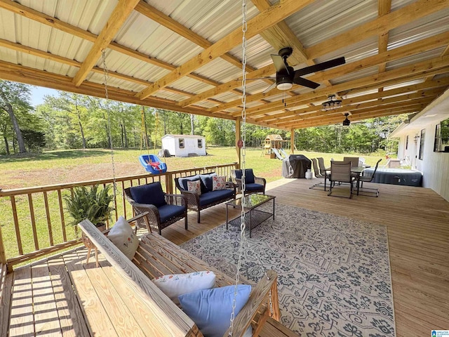 632 Bernard Couch Dr, Anniston, AL 36207 - wooden terrace featuring an outdoor structure, outdoor lounge area, a shed, outdoor dining space, and a lawn