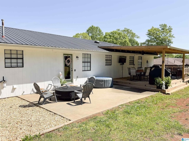 632 Bernard Couch Dr, Anniston, AL 36207 - back of property featuring an outdoor fire pit, a patio, a wooden deck, and metal roof