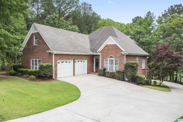 43 Dogwood Dr, Calera, AL 35040 - view of front facade featuring brick siding, an attached garage, a front yard, and concrete driveway