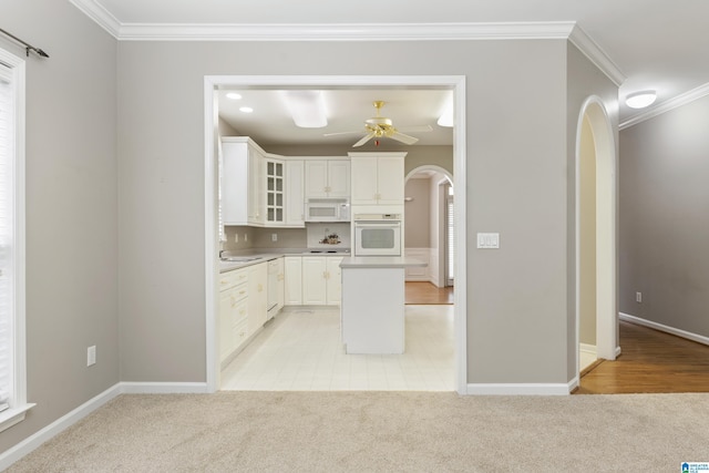 43 Dogwood Dr, Calera, AL 35040 - kitchen with crown molding, ceiling fan, white appliances, arched walkways, and glass insert cabinets