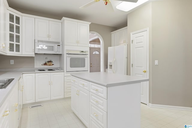 43 Dogwood Dr, Calera, AL 35040 - kitchen featuring white appliances, arched walkways, a ceiling fan, light tile patterned floors, and visible vents