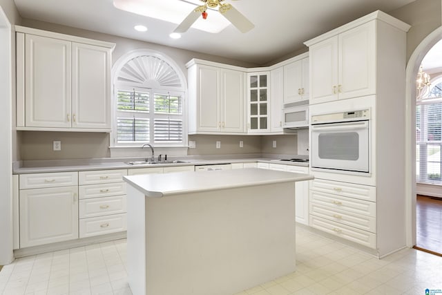 43 Dogwood Dr, Calera, AL 35040 - kitchen with a sink, light countertops, glass insert cabinets, recessed lighting, and white appliances